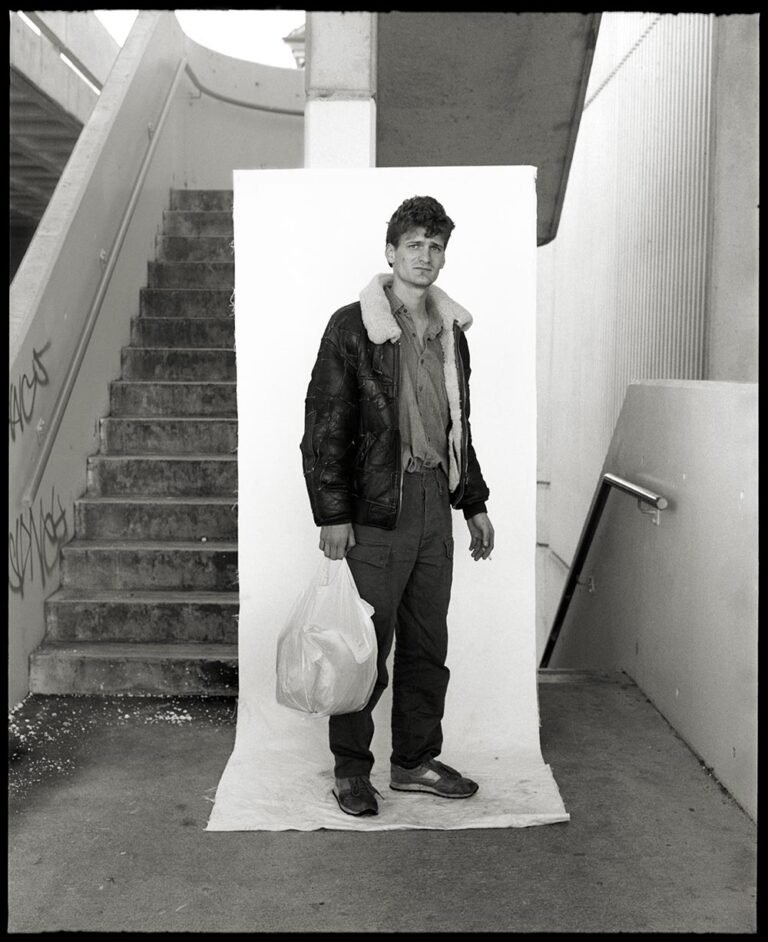 Belconnen Mall parking area stairwell 1990: Man with leather jacket, shopping bag and cigarette