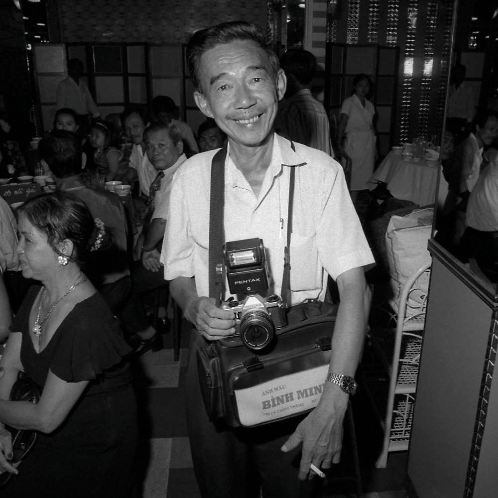 Portrait of a photgrapher in Saigon (1996), by Spiros Coutroubas - part of a series of documentary photographs of people and places in Vietnam in the 1990s