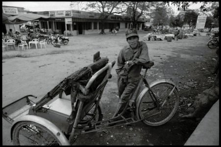 Photographic portrait of a cyclo driver by Spiros Coutroubas, Hue, Vietnam, 1996 Vietnam 1995: portrait of a cyclo driver in Hue by Spiros Coutroubas, part of a series of documentary photographs of people and places in Vietnam in the 1990s