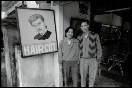Photographic portrait of two men at a barber shop in Dalat, by Spiros Coutroubas, Vietnam, 1996 Vietnam 1996: portrait of men at a barber shop, Dalat, by Spiros Coutroubas - part of a series of documentary photographs of people and places in Vietnam in the 1990s