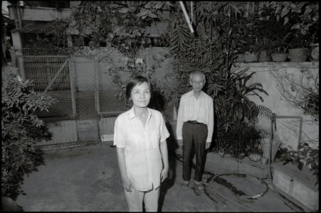 Photographic portrait of Ms Tuyet and her husband at home by Spiros Coutroubas, Ho Chi Minh City, Vietnam, 1997 Vietnam 1997: portrait of Ms Tuyet and her husband at home in Saigon, by Spiros Coutroubas - part of a series of documentary photographs of people and places in Vietnam in the 1990s