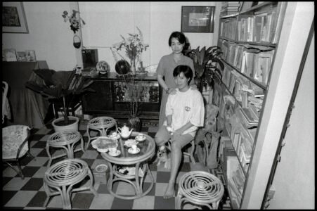 Photographic portrait of two Ms Hiens at the seated Ms Hien's home by Spiros Coutroubas, Ho Chi Minh City, Vietnam, 1997 Vietnam 1997: portrait of two Ms Hiens at the seated Ms Hien's home in Saigon, by Spiros Coutroubas - part of a series of documentary photographs of people and places in Vietnam in the 1990s