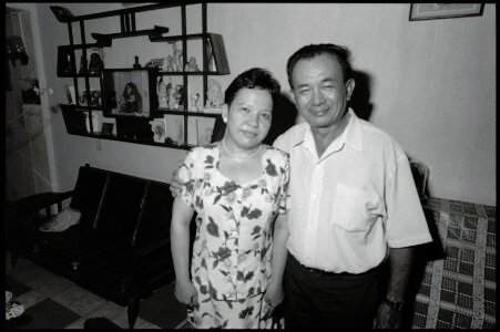 Photographic portrait of Ms Thanh My and Raymond at home by Spiros Coutroubas, Ho Chi Minh City, Vietnam, 1997 Vietnam 1997: portrait of Ms Thanh My and Raymond at home in Saigon, by Spiros Coutroubas - part of a series of documentary photographs of people and places in Vietnam in the 1990s